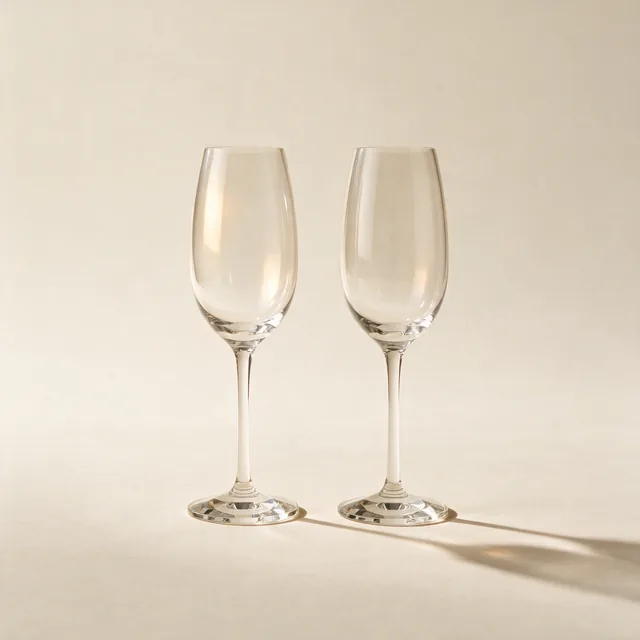 Two crystal wine glasses standing side by side