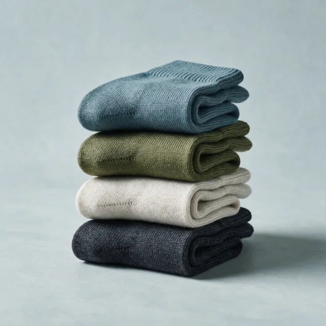 Four folded pairs of merino wool socks stacked
