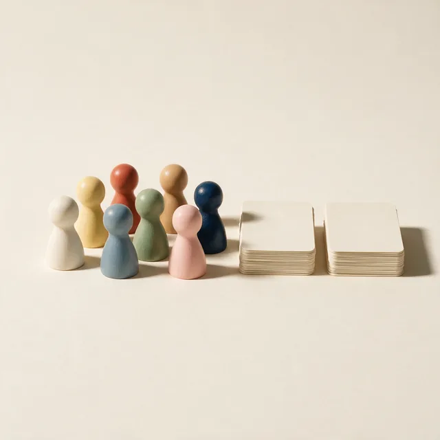 Wooden meeples beside two stacked decks of plain-backed cards