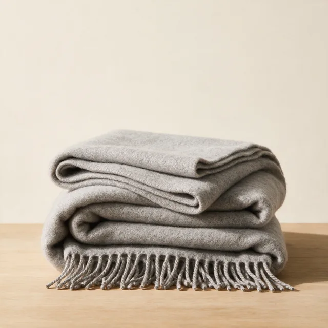 A folded lambswool throw in heather gray