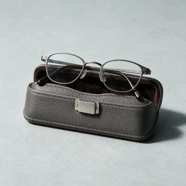 Reading glasses folded on their hard case