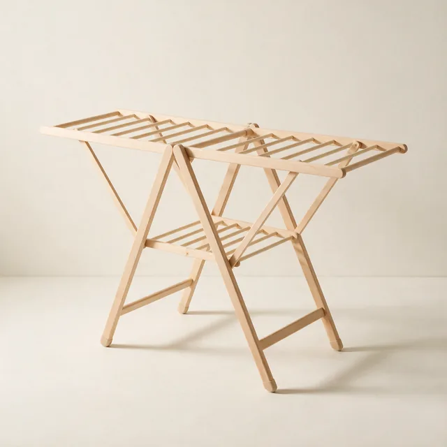 A folding wooden clothes airer, opened and empty