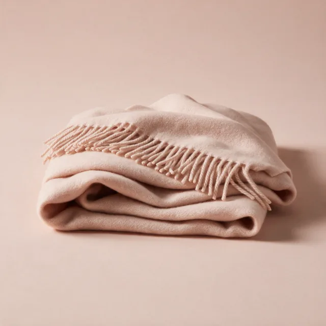 A folded lambswool wrap with a fringed edge